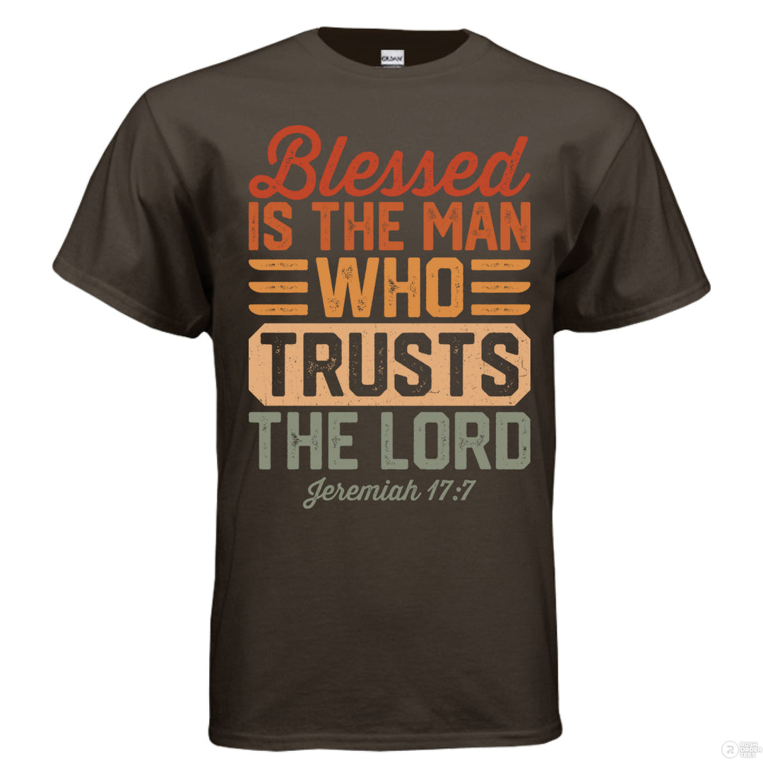 Dark chocolate Christian t-shirt with bold distressed text in warm tones reading ‘Blessed is the man who trusts the Lord – Jeremiah 17:7’