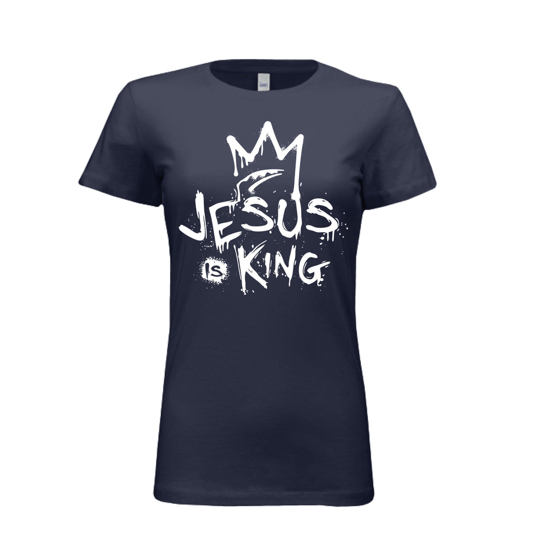 Navy women’s fitted t-shirt with bold white graffiti-style design reading “Jesus Is King” under a crown. Urban faith statement piece.