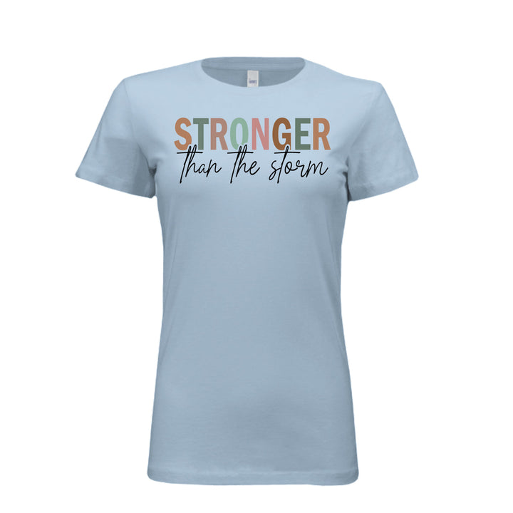 Women's fitted tee in baby blue with bold multi-color “STRONGER” and black script “than the storm” across the chest.